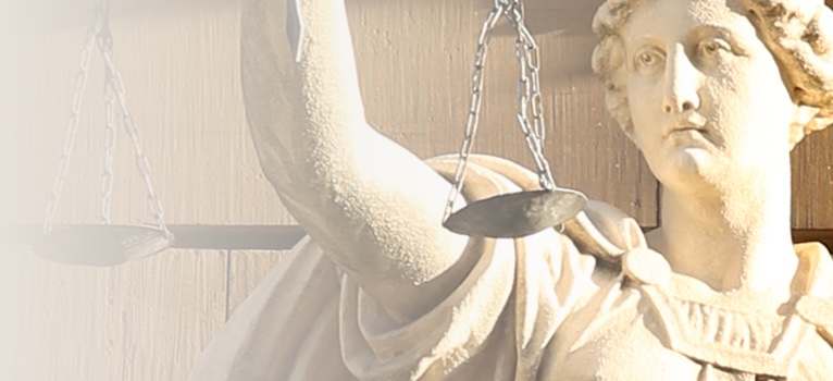 A statue of Justice holding a scale, symbolizing fairness and legal options in the claims process.